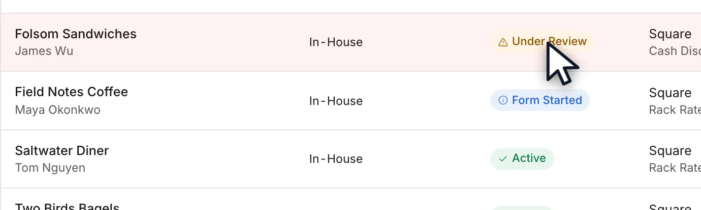 A merchant row carrying an amber Under Review badge in the Merchant Status column.
